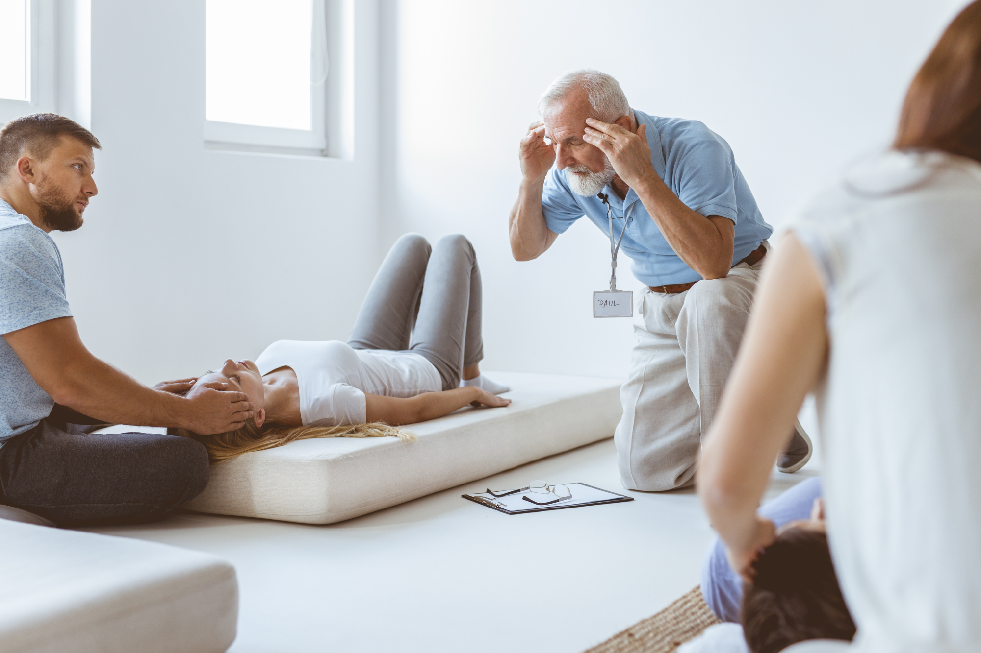 Therapist guiding a female patient during a cognitive behavioral therapy session, focusing on emotional regulation and distress tolerance in a serene treatment setting.