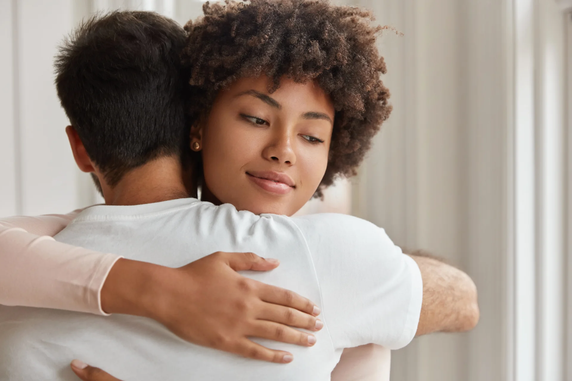 Couple embracing in a supportive moment, reflecting emotional connection and care during recovery from substance use disorder.