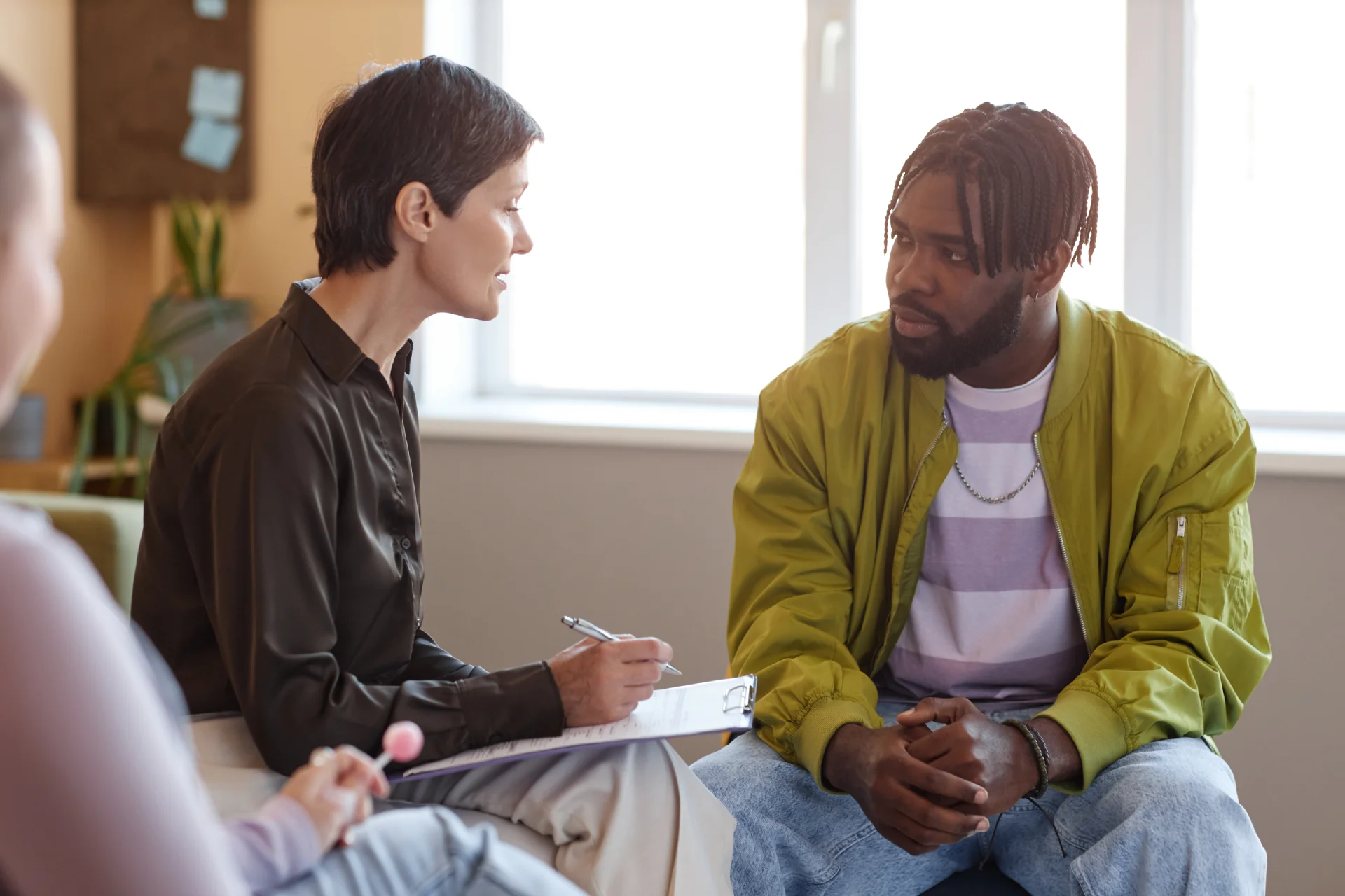 Counselor engaging in a supportive conversation with a client in a recovery setting, emphasizing emotional healing and personalized care for substance use disorders.