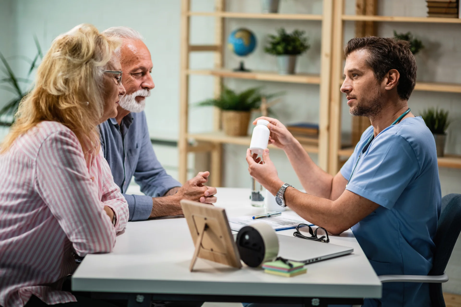 Doctor discussing medication with elderly couple in a clinical setting, highlighting treatment options for anxiety and addiction management.