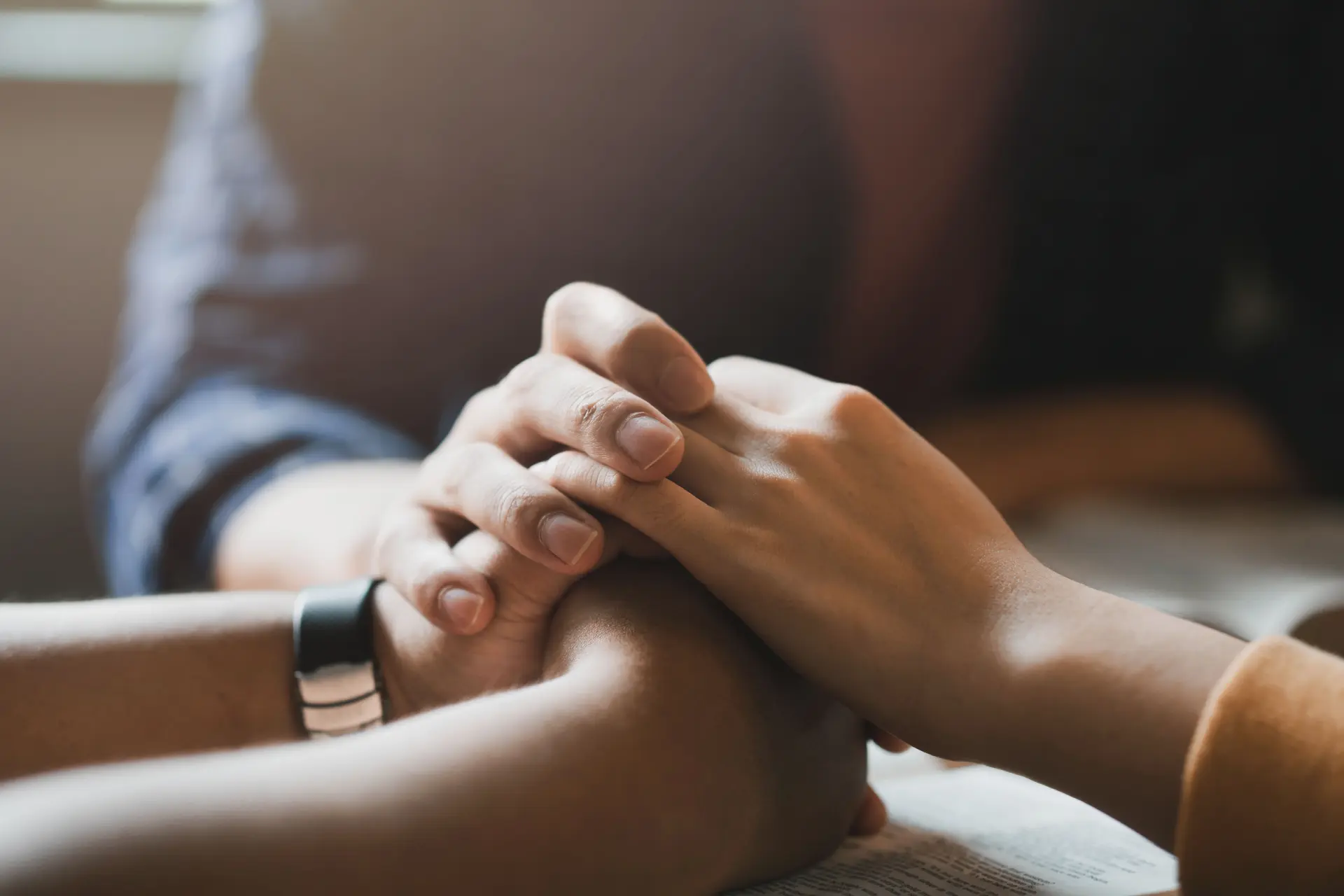 A group of people holding hands in a show of support