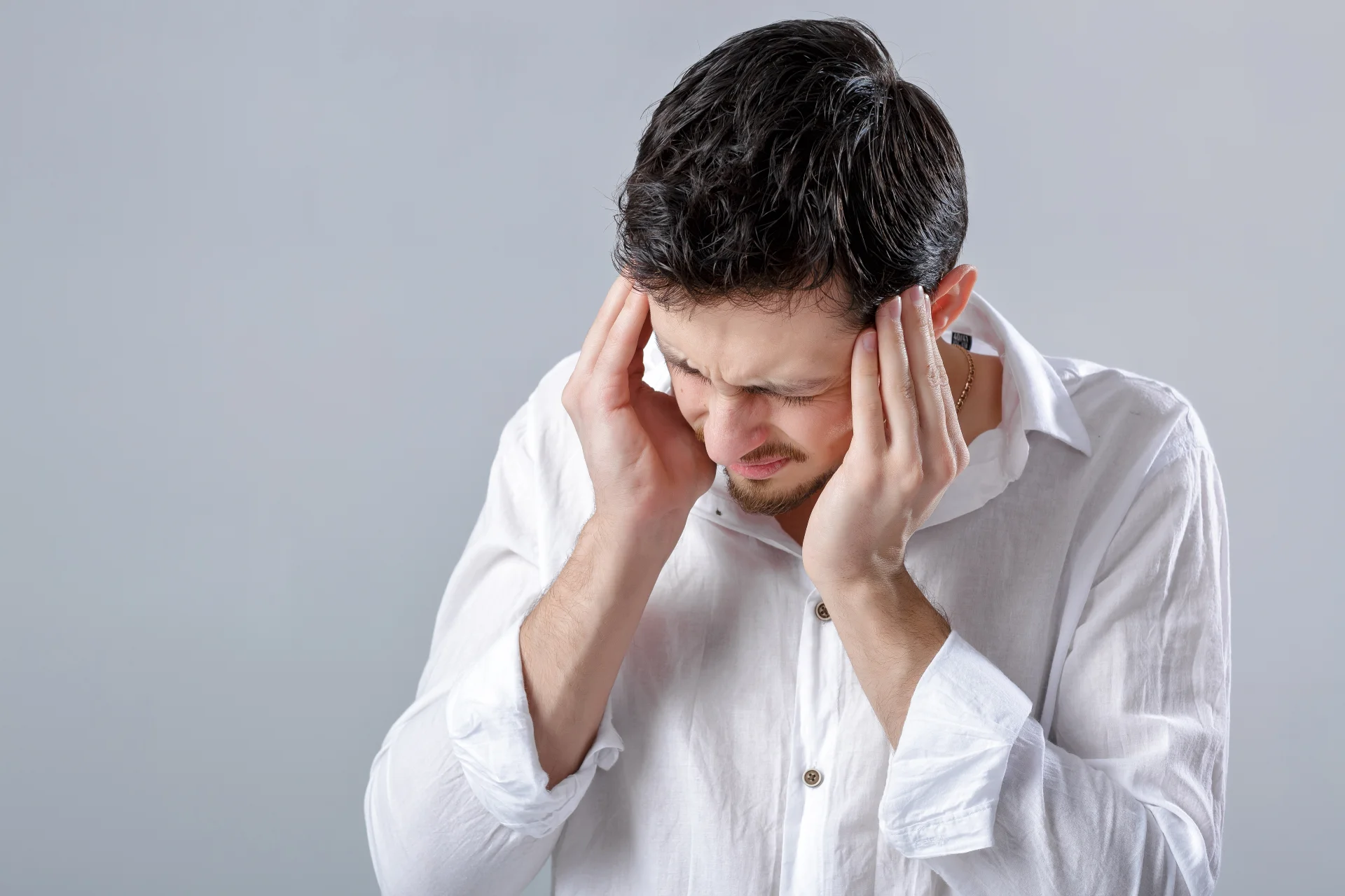 Frustrated man holding his head, expressing distress related to psychological withdrawal symptoms from Focalin misuse, emphasizing the emotional toll of addiction recovery.