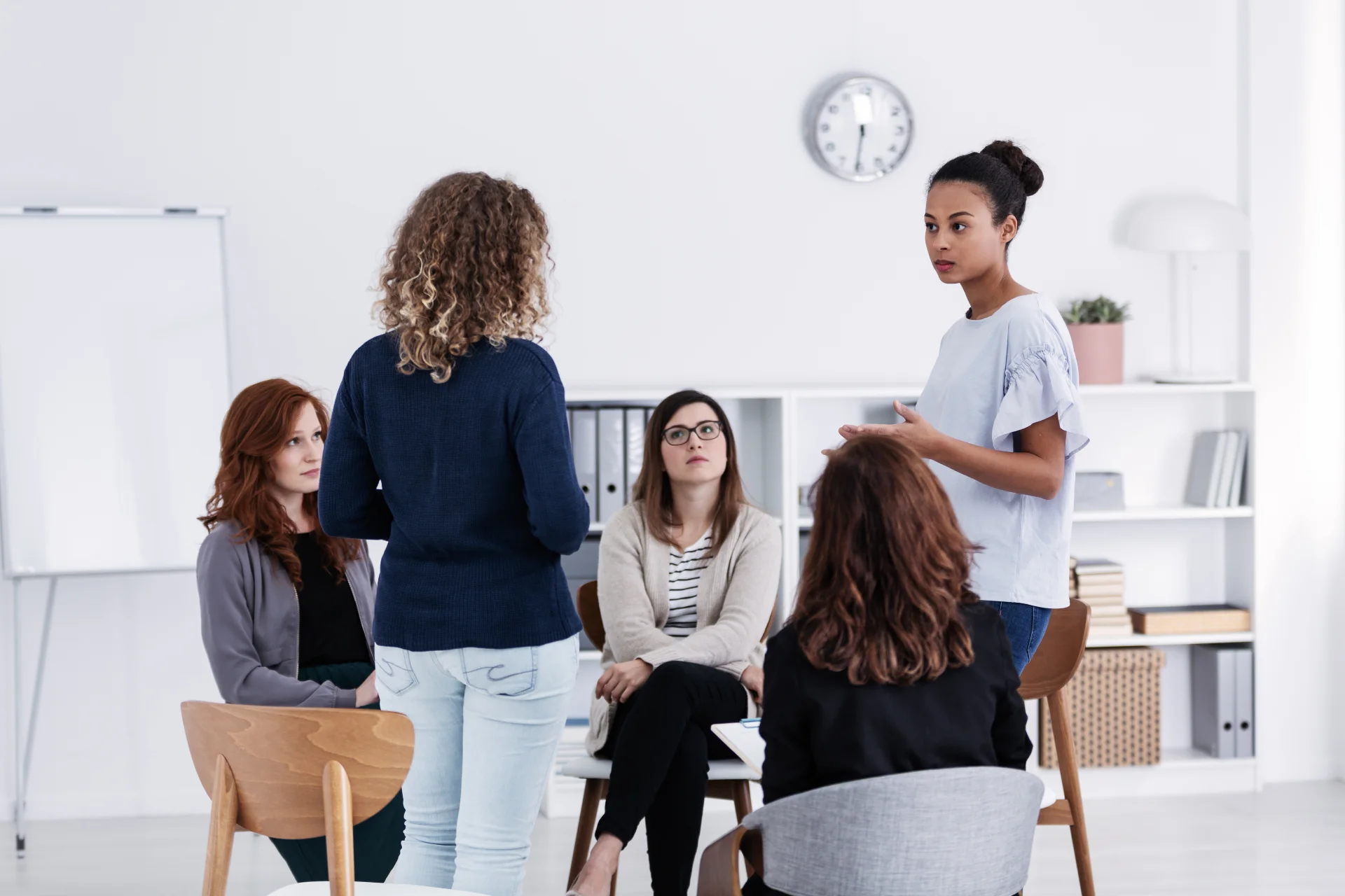 Women engaging in a group therapy session focused on addiction recovery, discussing personal experiences and support in a safe, women-only environment.