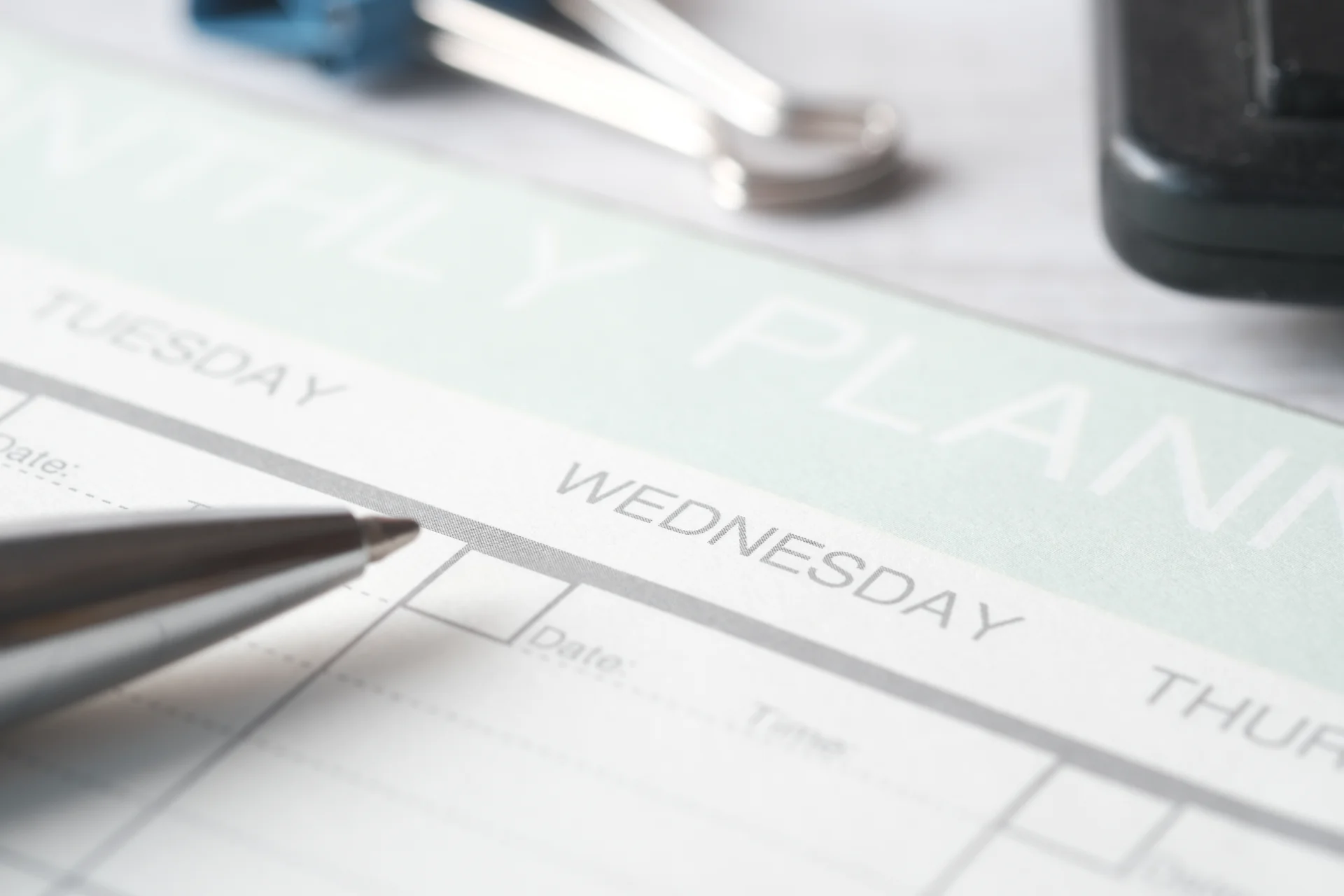 Weekly planner page with a focus on Wednesday, featuring a silver pen, emphasizing organization and scheduling for addiction treatment and recovery planning.